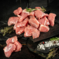 Schweinegulasch vor dunklem Hintergrund